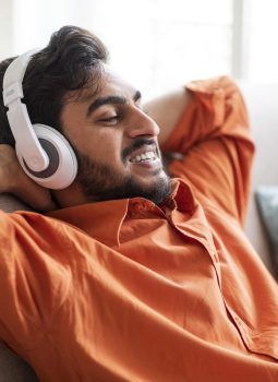 positive-arab-guy-reclining-on-sofa-singing-songs-2023-01-09-22-17-18-utc-compressed
